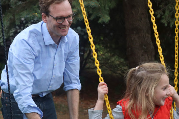 Tom pushing his daughter Mary on a swing